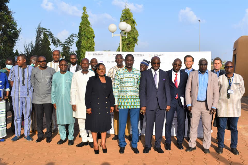 Official ribbon cutting ceremony with dignitaries in professional attire and festive atmosphere