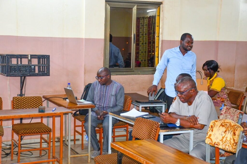 University students and presenters engaged in a workshop setting with colorful furniture